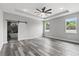 Main bedroom features a sliding barn door to the bathroom and bright windows with backyard views at 2724 W Dewey St, Tampa, FL 33607