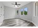 Bedroom with ample natural light, wood-look flooring, and a ceiling fan at 2724 W Dewey St, Tampa, FL 33607