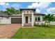 Charming home with a welcoming front yard, a well-manicured lawn and a brick driveway at 2724 W Dewey St, Tampa, FL 33607