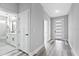 Bright hallway connecting the bathroom and front entrance, with modern flooring at 2724 W Dewey St, Tampa, FL 33607