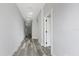 Bright hallway with recessed lighting and modern flooring leads to various rooms in the home at 2724 W Dewey St, Tampa, FL 33607