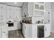Kitchen features a wine bar with built-in wine cooler, white cabinets, and subway tile backsplash at 2724 W Dewey St, Tampa, FL 33607