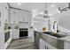 Modern kitchen featuring stainless steel appliances, white cabinetry, subway tile backsplash, and a stone countertop at 2724 W Dewey St, Tampa, FL 33607