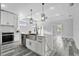 Bright kitchen features stainless steel appliances, large island with waterfall counters, and modern pendant lighting at 2724 W Dewey St, Tampa, FL 33607