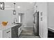 Kitchen with stainless appliances, white cabinets, stone countertops, and an undermount farmhouse sink at 2724 W Dewey St, Tampa, FL 33607