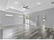 Large living room with gray wood flooring and sliding glass doors to the backyard at 2724 W Dewey St, Tampa, FL 33607