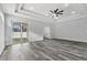 Bright living room with tray ceiling, ceiling fan, and sliding glass doors to the backyard patio at 2724 W Dewey St, Tampa, FL 33607