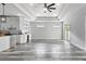 Open-concept living room and kitchen with modern gray wood floors and plenty of natural light at 2724 W Dewey St, Tampa, FL 33607