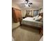 Bedroom with neutral carpeting, wood furniture, and cozy bedding at 18135 Canal Pointe St, Tampa, FL 33647