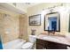 Clean bathroom with granite vanity and a large mirror at 1528 Chevy Chase Dr, Sun City Center, FL 33573