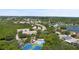 Community overview showing homes, lake, and recreational amenities at 568 Shoreham Ne Ct, St Petersburg, FL 33716