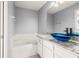 Bathroom with granite countertop, blue glass sink, and bathtub at 568 Shoreham Ne Ct, St Petersburg, FL 33716