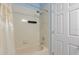 Bathroom with tub and shower, and white tile at 568 Shoreham Ne Ct, St Petersburg, FL 33716