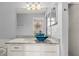 Bathroom with granite countertop, dual sinks, and blue glass bowls at 568 Shoreham Ne Ct, St Petersburg, FL 33716