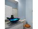 Bathroom with blue glass vessel sink and granite vanity at 568 Shoreham Ne Ct, St Petersburg, FL 33716