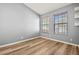 Simple bedroom with wood-look floors and two windows at 568 Shoreham Ne Ct, St Petersburg, FL 33716