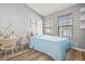 Bedroom with light blue bedding and wood-look floors at 568 Shoreham Ne Ct, St Petersburg, FL 33716