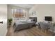 Spacious bedroom with a bed, desk and wood-look floors at 568 Shoreham Ne Ct, St Petersburg, FL 33716