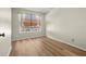 Bright bedroom with wood-look floors and large window at 568 Shoreham Ne Ct, St Petersburg, FL 33716