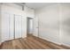 Bedroom with wood-look floors and double door closet at 568 Shoreham Ne Ct, St Petersburg, FL 33716