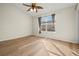 Light-filled bedroom with wood flooring and large window at 568 Shoreham Ne Ct, St Petersburg, FL 33716