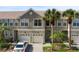 Two-story townhome with double garage and palm trees at 568 Shoreham Ne Ct, St Petersburg, FL 33716