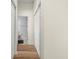 Hallway featuring wood flooring and access to bathroom and closets at 568 Shoreham Ne Ct, St Petersburg, FL 33716