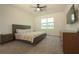 Main bedroom features a neutral color palette, a window, and a ceiling fan at 9293 Rally Spring Loop, Wesley Chapel, FL 33545