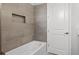 Clean bathroom with bathtub and grey tile at 3221 20Th N St, St Petersburg, FL 33713