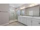 Elegant bathroom with double vanity, frameless shower, and gray tile at 3221 20Th N St, St Petersburg, FL 33713