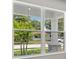 Large window showcasing a view of lush landscaping and homes at 3221 20Th N St, St Petersburg, FL 33713