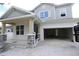 Two-story home with gray siding, stone accents, and a two-car garage at 3221 20Th N St, St Petersburg, FL 33713