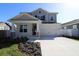 Two-story Craftsman style home with a gray exterior, stone accents, and a two-car garage at 3221 20Th N St, St Petersburg, FL 33713