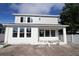 Two-story home with gray siding, covered porch, and backyard at 3221 20Th N St, St Petersburg, FL 33713