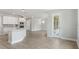 Modern kitchen with white cabinets, island, and gray flooring at 3221 20Th N St, St Petersburg, FL 33713