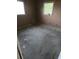 A bedroom with worn carpet and two windows at 1716 Lancelot Loop, Tampa, FL 33619