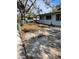 View of the front yard with a large tree and driveway at 1716 Lancelot Loop, Tampa, FL 33619