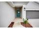 Teal front door and walkway leading to a two-car garage at 6907 162Nd E Pl, Parrish, FL 34219