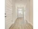 Light-filled hallway with wood-look tile floors and white doors at 6907 162Nd E Pl, Parrish, FL 34219