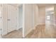 Light and airy hallway with wood-look tile floors at 7030 162Nd E Pl, Parrish, FL 34219