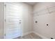 Laundry room with built in shelving and a white door at 7014 162Nd Place E. E Pl, Parrish, FL 34219