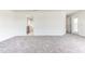 Large living room with grey carpet and access to other rooms at 7014 162Nd Place E. E Pl, Parrish, FL 34219