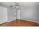 Hardwood floor bedroom with ceiling fan and double closets at 3022 Holiday Lake Dr, Holiday, FL 34691