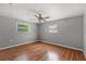 Simple bedroom with hardwood floors and ceiling fan at 3022 Holiday Lake Dr, Holiday, FL 34691