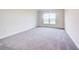 Bright bedroom with gray carpeting and a window at 6814 162Nd E Pl, Parrish, FL 34219