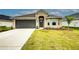 One-story home with attached garage and landscaped lawn at 6814 162Nd E Pl, Parrish, FL 34219