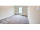 Bright bedroom featuring gray carpeting and a window at 7018 162Nd E Pl, Parrish, FL 34219