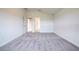 Spacious bedroom with gray carpeting and access to bathroom at 7018 162Nd E Pl, Parrish, FL 34219