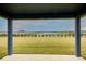 Covered patio overlooking a backyard and lake view at 7018 162Nd E Pl, Parrish, FL 34219