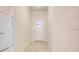 Light and airy entryway with wood-look flooring and neutral walls at 7018 162Nd E Pl, Parrish, FL 34219